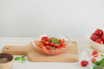 Fresh delicious salad with tomatoes. Doing fresh green salad