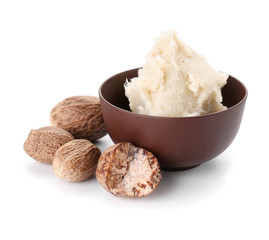 Bowl with shea butter on white background