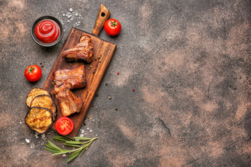 Board with tasty grilled meat on grey background