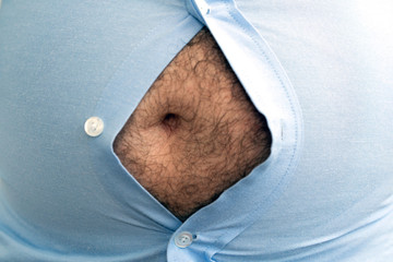 man with overweight. symbolic photo for beer belly, unsuccessful dieting and eating the wrong...