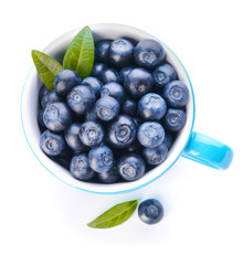 Cup with ripe blueberry on white background