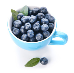 Cup with ripe blueberry on white background