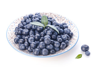 Plate with ripe blueberry on white background