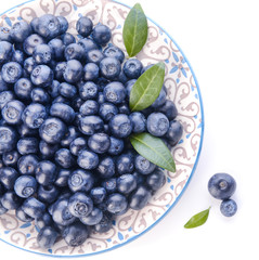 Plate with ripe blueberry on white background