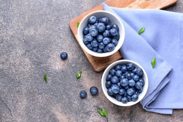 Fototapeta na wymiar Bowls with ripe blueberry on table