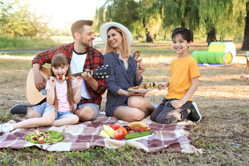Happy family having picnic on summer day