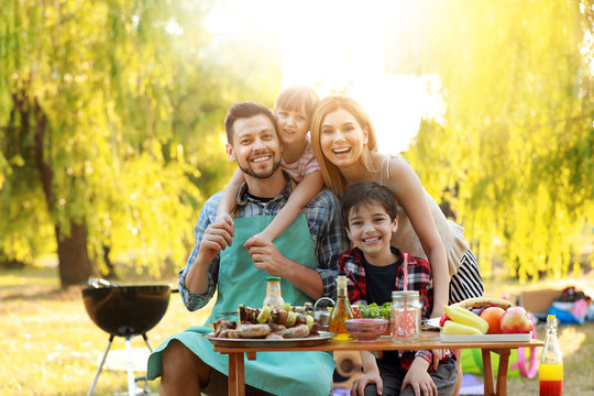 Happy family having picnic on summer day