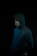 Hacker with laptop initiating cyber attack, isolated on black backgroung