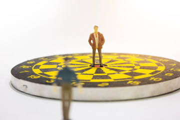 miniature businessman on target. business competition concept.