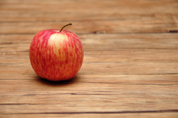 A red apple on a wooden background