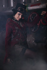 Fototapeta na wymiar Portrait of a young steampunk woman shrouded in steam