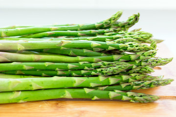 Asparagus on a cutting board in the kitchen