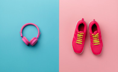 A studio shot of running shoes and headphones on color background.