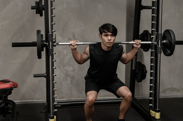 Fototapeta na wymiar Asian men exercise at the gym