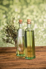 Olive tree and bottles with oil, olives on a wood table
