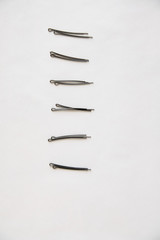 black metal hairpins are vertical and straight on a white background