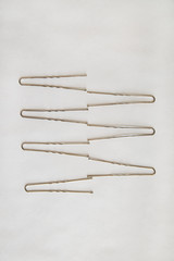 silver metal hairpins are on a white background in the form of a zigzag