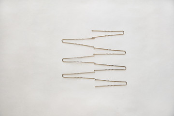 silver metal hairpins are on a white background in the form of a zigzag