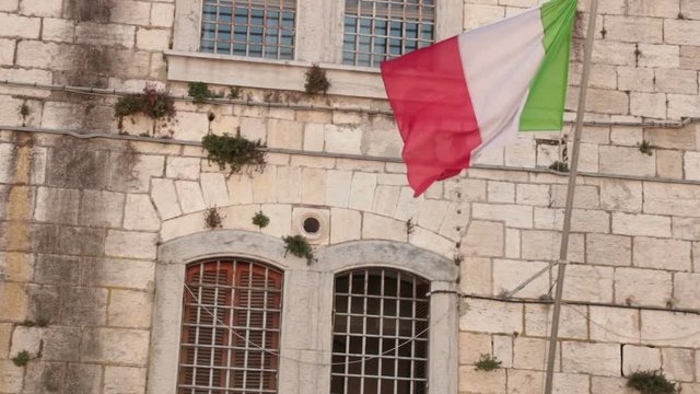italian flag in a military building. One of the most important buildings in Peschiera. First military hospital, then barracks and finally military prison