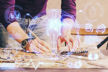 Man's hands working with notes background. Modern computer record diagram with virtual mnitor.