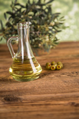 Olive oil, olive tree and green olives, bottles of olive oil