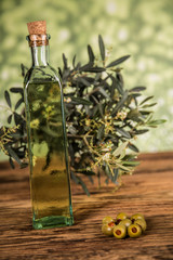 Olive oil, olive tree and green olives, bottles of olive oil