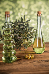 Olive oil, olive tree and green olives, bottles of olive oil