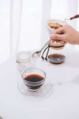 Glass of black coffee with man hand put a spoon of sugar, Diet fitness and Unhealthy concept