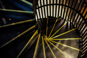 Modern black spiral staircase and bronze metal stair nosing with black handrail high angle view