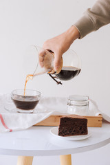 Brewing nel drip coffee. Step by step cooking instructions. Coffee is ready. Barista pouring brewed coffee in the cup
