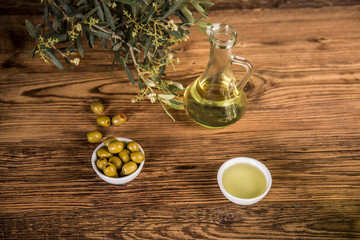 Olive oil, olive tree and green olives, bottles of olive oil