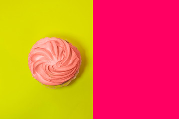 Homemade strawberry cupcake with butter cream on bright background.
