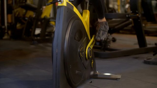 Close up shot of a female feet doing cycling in a fitness club