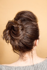 Rear view of female hairstyle middle bun with brown hair
