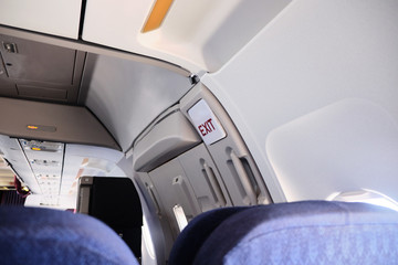 Empty aircraft cabin close up. Emergency exit