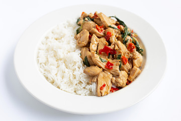 Rice topped with stir-fried chicken and holy basil on white