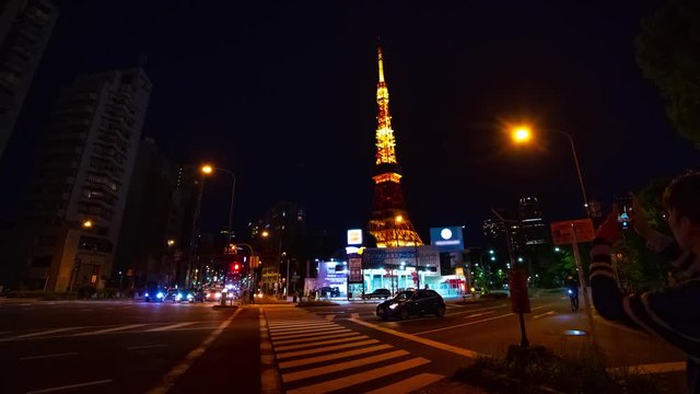 A timelapse at the crossing behind the high tower at night panning. Minato district Tokyo / Japan - 04.27.2019 : Here's called Tokyo tower. camera : Canon EOS 5D mark4