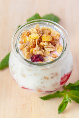 healthy products for breakfast, granola and fresh berries on white table