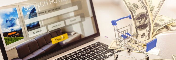 Small shopping cart with Laptop for shopping online concept.selective focus