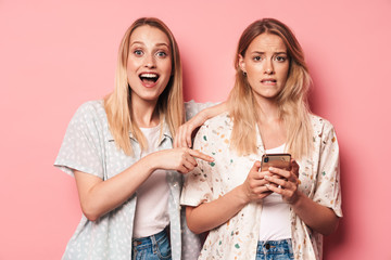 Two attractive blonde girls wearing summer outfit