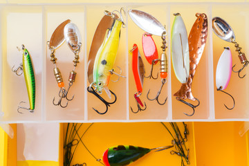 Fishing hooks and bait in a set for catching different fish.