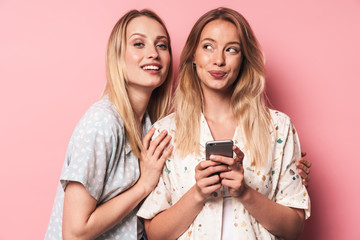 Two attractive blonde girls wearing summer outfit