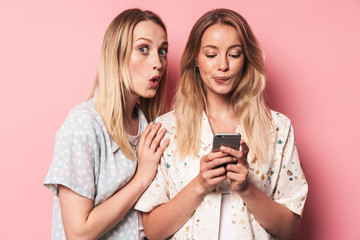 Two attractive blonde girls wearing summer outfit