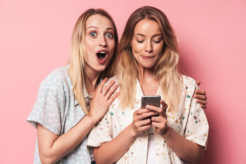 Two attractive blonde girls wearing summer outfit