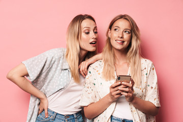 Two attractive blonde girls wearing summer outfit