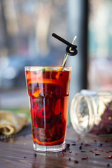 Healthy red cocktail with fruits and ice