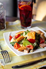 Healthy salad with сherry tomatoes, chicken, crackers, greens