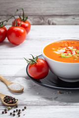 Gazpacho. Traditional Spanish tomato soup with fresh tomatoes, fresh cucumber , on white wood base