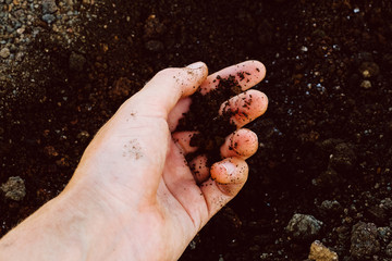 Nicaragua. Cerro Negro. Female hand touches brown sand on a volcano