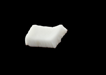 Coconut piece isolated on black background